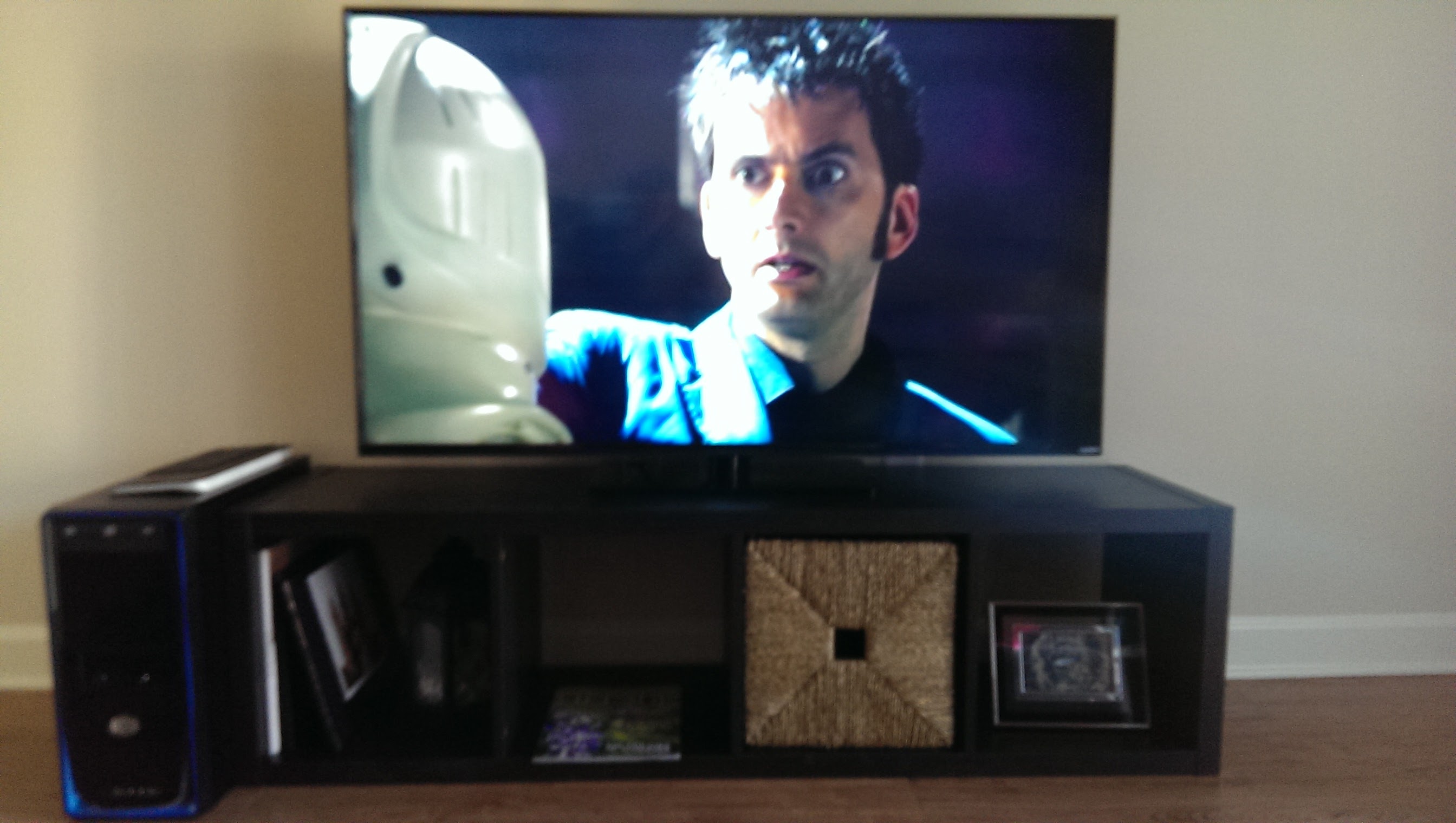 Entertainment center with a TV showing Doctor Who